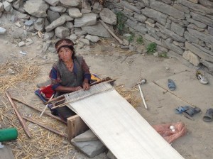 Gatlang Village woman weaving a traditional Tibetan shawl